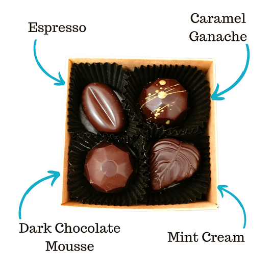 Image shows Fetcha Chocolates handmade box of four dark filled chocolates, with labels highlighting the different flavours. These chocolates are vegan, dairy free, gluten free and soy free and come in plastic-free packaging.