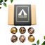 Image shows Fetcha Chocolates handmade Classic collection (a mix of milk, dark and white chocolate) which are vegan, dairy free, gluten free and soy free and come in plastic-free packaging. Image shows six chocolates sitting next to a kraft box with black and gold branding.