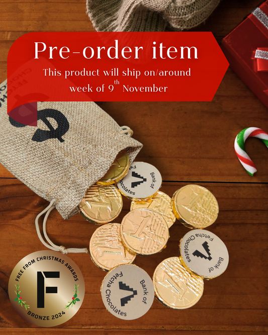Gold foil wrapped vegan chocolate coins with Fetcha Chocolates stickers on a wooden surface, accompanied by a red pre-ordering banner.