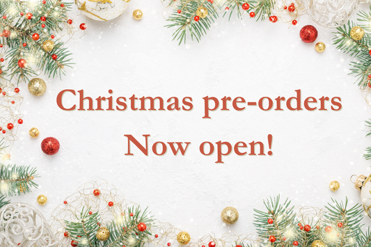 Christmas-themed promotional banner with 'Christmas pre-orders Now open!' text surrounded by festive decorations.