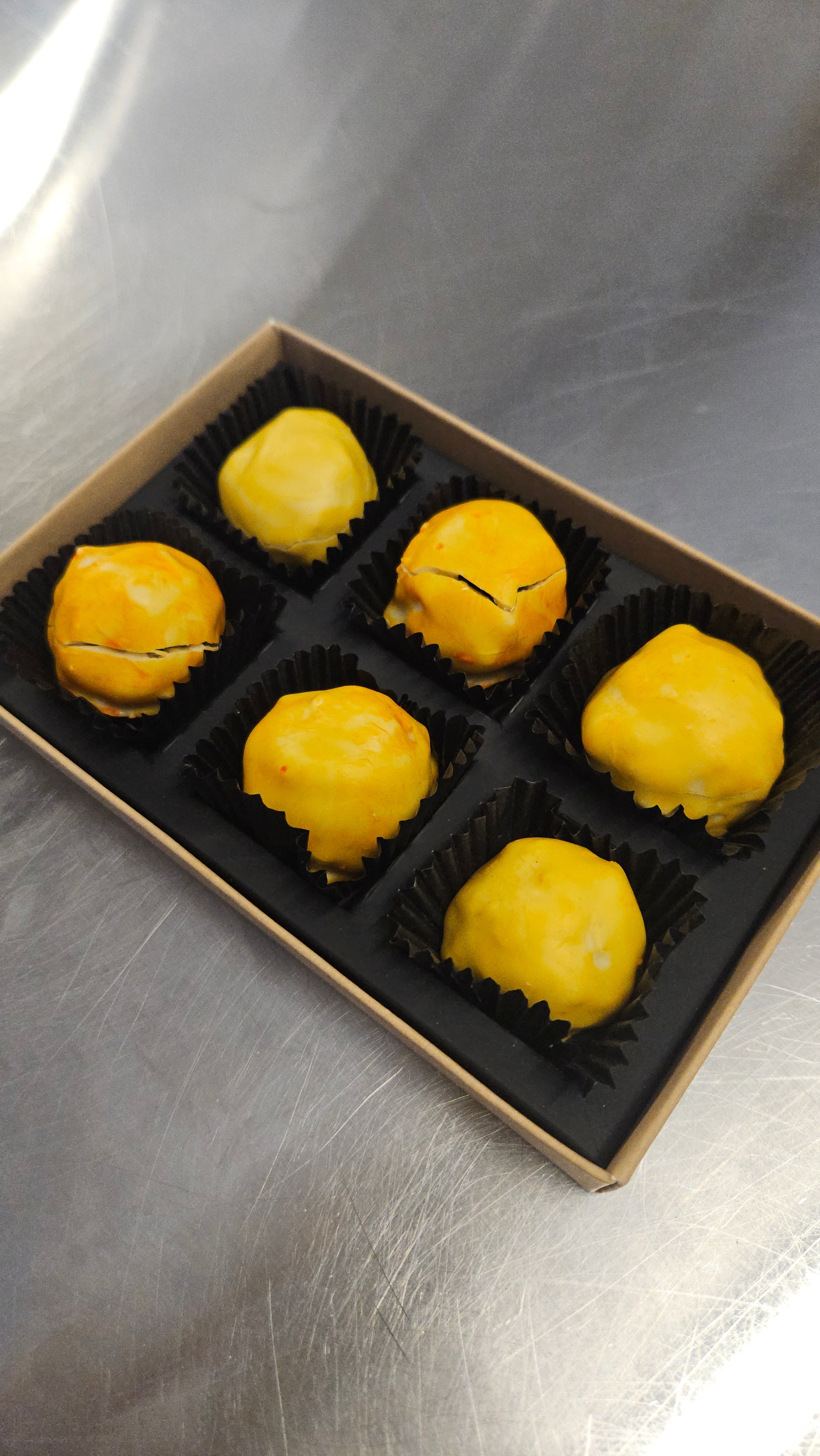 Box of yellow vegan luxury chocolates