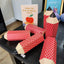 Image shows 6 pencil shaped boxed on table. Pencil shaped boxes being used as packaging for Fetcha Chocolate products