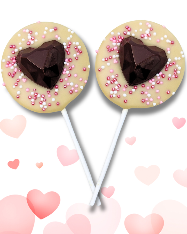 Two lollipops with heart shapes and sprinkles on a white background 
