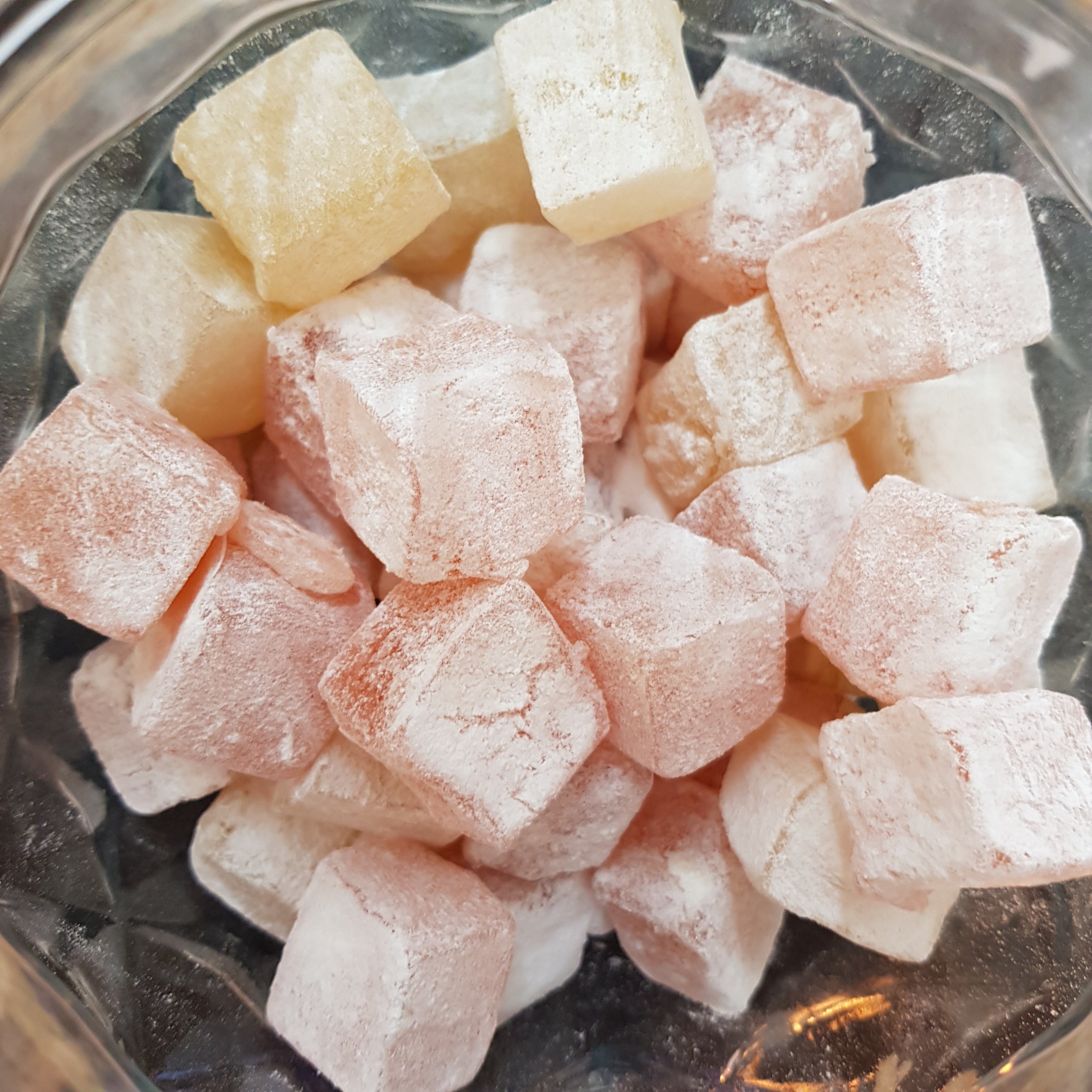 Image shows an inside look: jar of vegan turkish delight, yellow and pink for lemon and rose being sold by Fetcha Chocolates