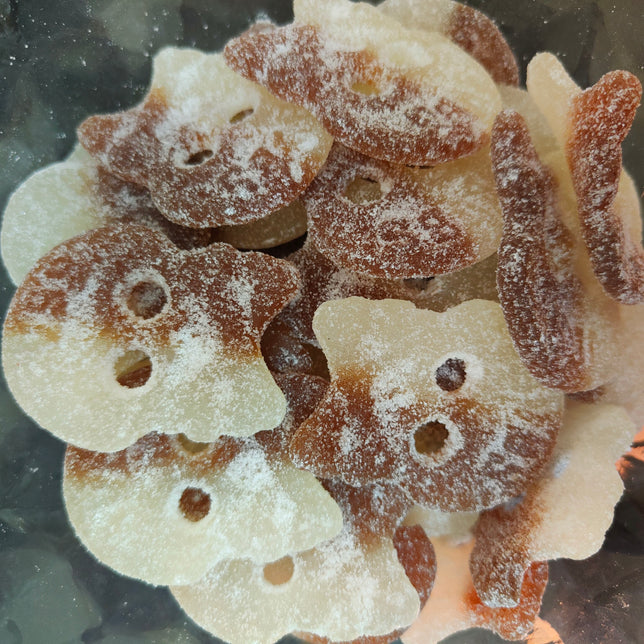 Image shows a clear container full of sweet and sour cola bub sweets, being sold by Fetcha Chocolates