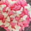 Image shows a clear container full of pink and white jelly bean heart sweets, being sod by Fetcha Chocolates
